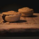 brown wooden chopping board with brown and white round food